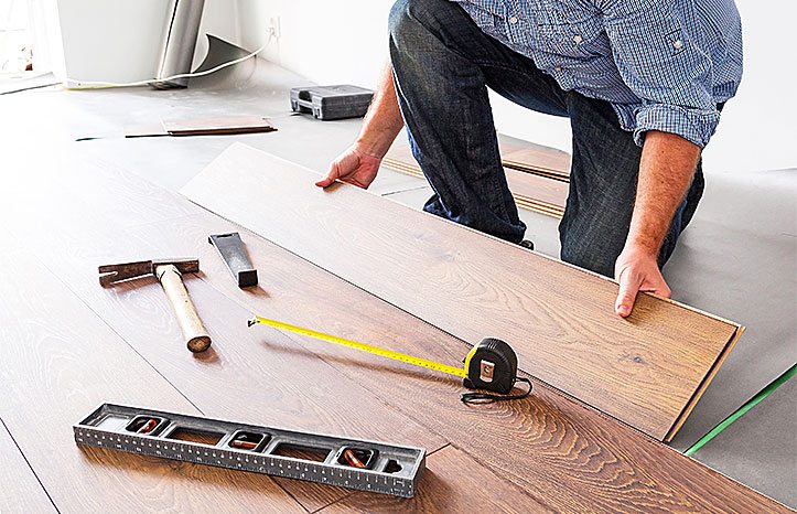 Small business owner installing flooring